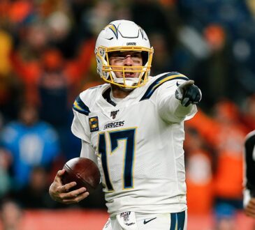 Los Angeles Chargers quarterback Philip Rivers points with the ball in his hand at Empower Field at Mile High.