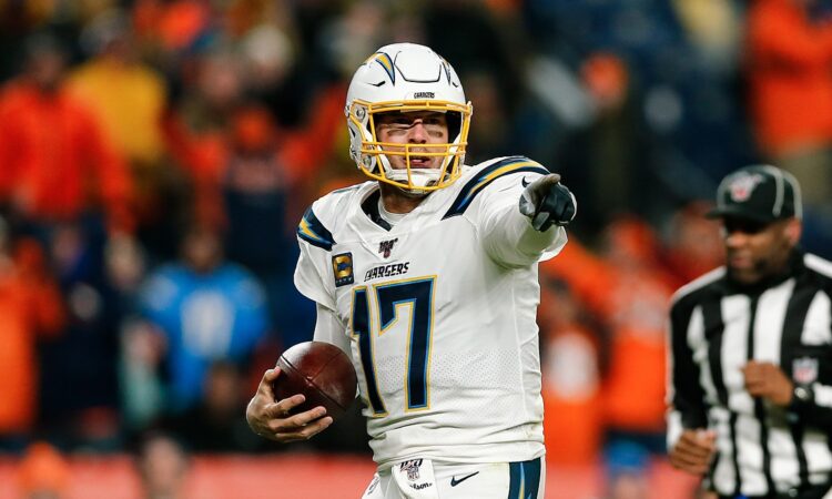 Los Angeles Chargers quarterback Philip Rivers points with the ball in his hand at Empower Field at Mile High.