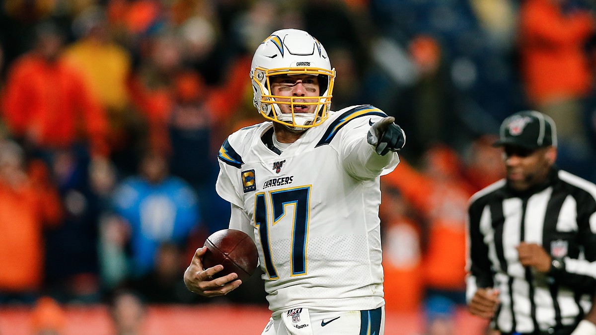 Los Angeles Chargers quarterback Philip Rivers points with the ball in his hand at Empower Field at Mile High.