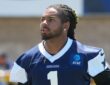 Dallas Cowboys safety P.J. Locke looks to his right during a training camp practice in a navy jersey.