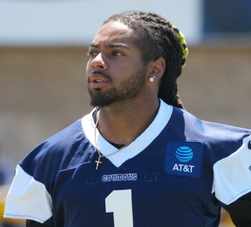 Dallas Cowboys safety P.J. Locke looks to his right during a training camp practice in a navy jersey.