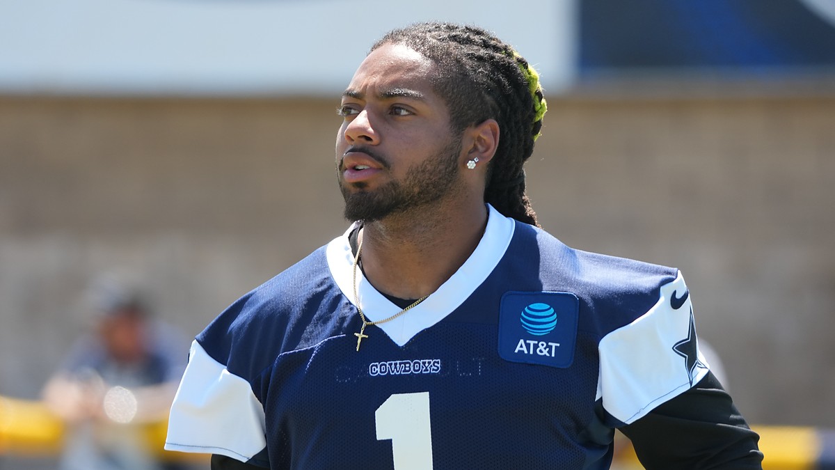 Dallas Cowboys safety P.J. Locke looks to his right during a training camp practice in a navy jersey.