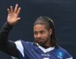 Cowboys safety P.J. Locke raises a hand during a break at training camp.
