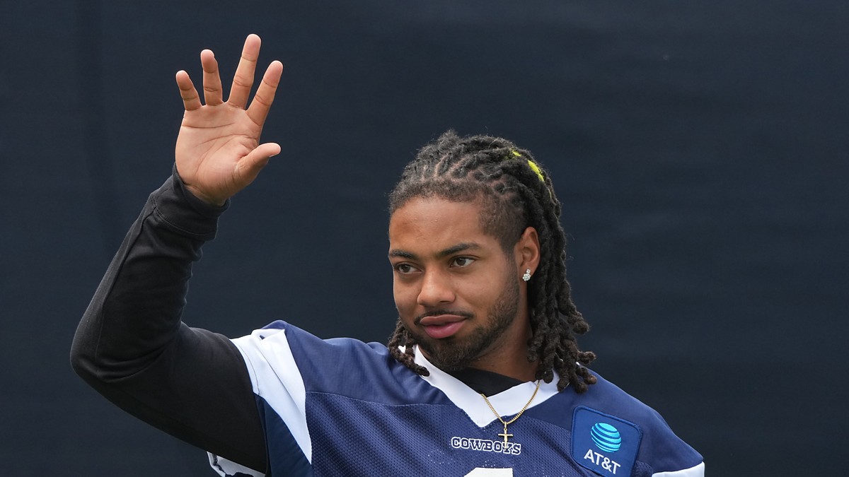 Cowboys safety P.J. Locke raises a hand during a break at training camp.