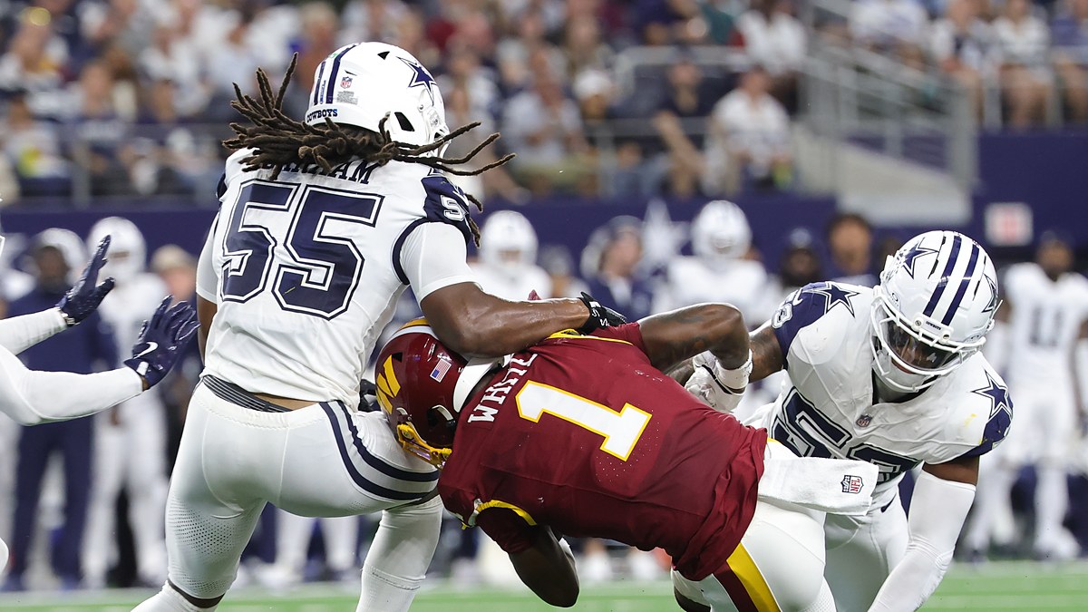 Dallas Cowboys linebackers Jaishawn Barham and Dee Winters wrap up Washington Commanders running back Rachaad White.