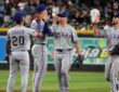 Texas Rangers players exchange high fives on the infield after a win over the Arizona Diamondbacks.