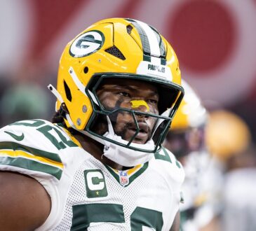 Green Bay Packers defensive lineman Rashan Gary looks toward the sideline in his helmet before a game against the Cardinals.