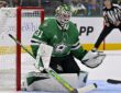Dallas Stars goaltender Rémi Poirier crouches in his crease beside the net, eyeing the play.