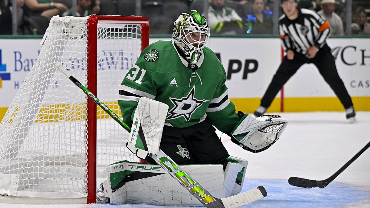 Dallas Stars goaltender Rémi Poirier crouches in his crease beside the net, eyeing the play.