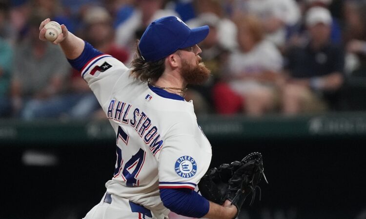 Texas Rangers pitcher Robby Ahlstrom reaches back with the ball as he throws to the plate against Boston.