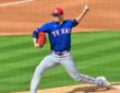 Texas Rangers pitcher Robert Garcia delivers in a blue spring training jersey at Tempe Diablo Stadium.