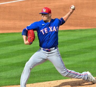 Texas Rangers pitcher Robert Garcia delivers in a blue spring training jersey at Tempe Diablo Stadium.