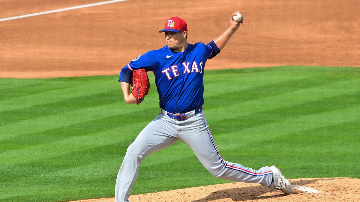 Texas Rangers pitcher Robert Garcia delivers in a blue spring training jersey at Tempe Diablo Stadium.