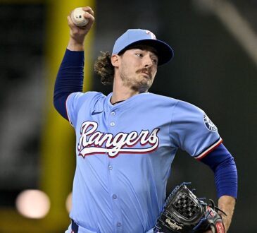 Texas Rangers relief pitcher Robert Garcia raises the ball in his delivery during a game against the Marlins.