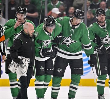 Dallas Stars center Roope Hintz is helped off the ice by teammates after an injury at American Airlines Center.