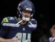 Seattle Seahawks quarterback Sam Darnold jogs out of the tunnel for warmups before a game against the Patriots.