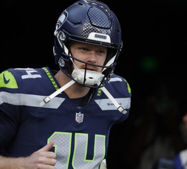 Seattle Seahawks quarterback Sam Darnold jogs out of the tunnel for warmups before a game against the Patriots.
