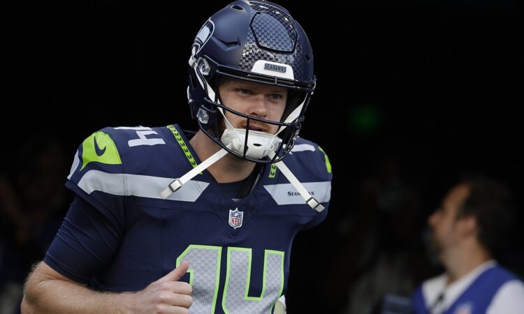 Seattle Seahawks quarterback Sam Darnold jogs out of the tunnel for warmups before a game against the Patriots.