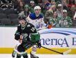 Stars center Sam Steel and Oilers center Connor McDavid skate side by side as both look up for the puck.