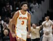 Atlanta Hawks forward Seth Lundy clenches his fists and shouts while running back up the court.