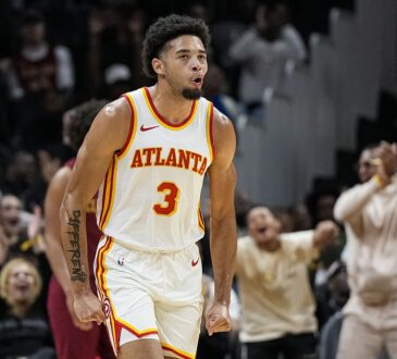 Atlanta Hawks forward Seth Lundy clenches his fists and shouts while running back up the court.