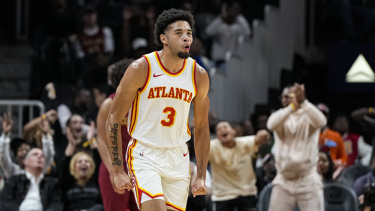 Atlanta Hawks forward Seth Lundy clenches his fists and shouts while running back up the court.