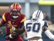 Washington Commanders quarterback Jayden Daniels loses the football as Dallas Cowboys linebacker Shemar James reaches in.