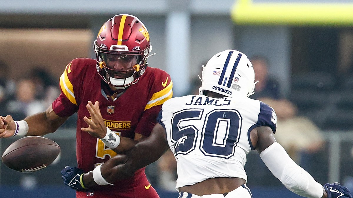 Washington Commanders quarterback Jayden Daniels loses the football as Dallas Cowboys linebacker Shemar James reaches in.