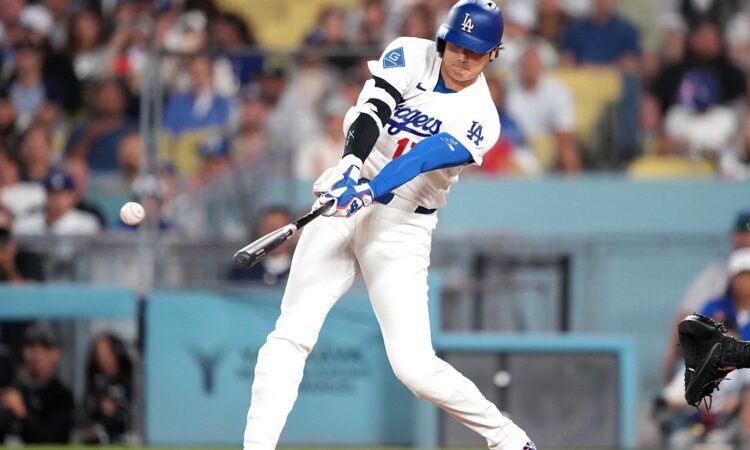 Los Angeles Dodgers batter Shohei Ohtani makes contact with a pitch during a game against the Cardinals.