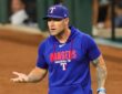 Texas Rangers manager Skip Schumaker turns with his palms up as he reacts during a game against Boston.