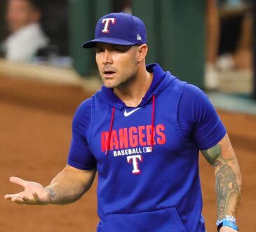 Texas Rangers manager Skip Schumaker turns with his palms up as he reacts during a game against Boston.