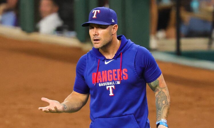 Texas Rangers manager Skip Schumaker turns with his palms up as he reacts during a game against Boston.
