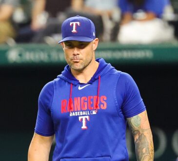 Texas Rangers manager Skip Schumaker walks toward the mound during a game against Boston.