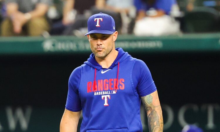 Texas Rangers manager Skip Schumaker walks toward the mound during a game against Boston.