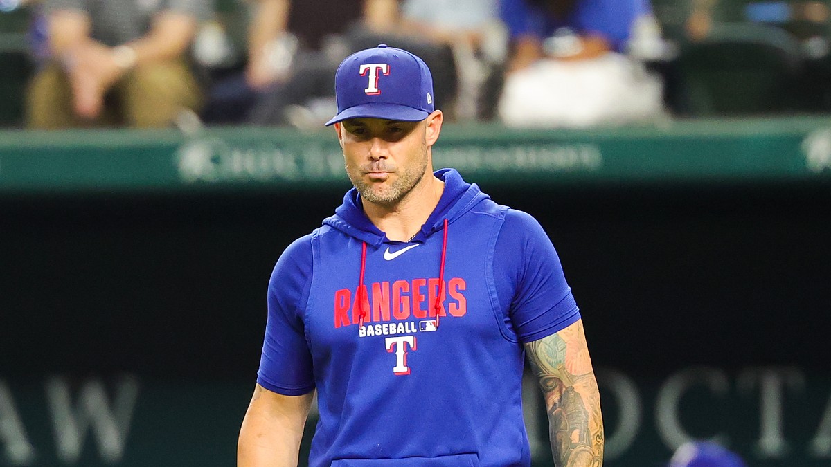 Texas Rangers manager Skip Schumaker walks toward the mound during a game against Boston.