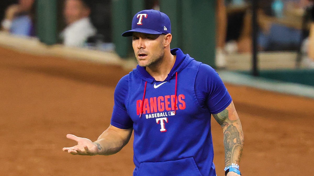 Texas Rangers manager Skip Schumaker turns with his palms up as he reacts during a game against Boston.