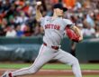 Red Sox pitcher Sonny Gray strides toward the plate mid-delivery with the ball in his raised right hand.