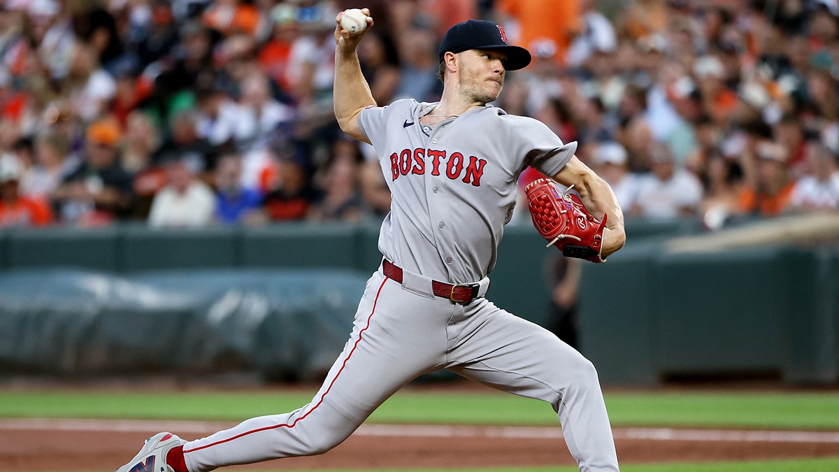 Red Sox pitcher Sonny Gray strides toward the plate mid-delivery with the ball in his raised right hand.