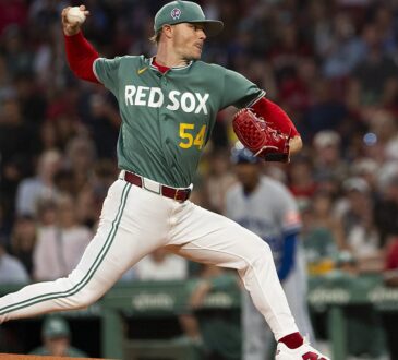 Boston Red Sox pitcher Sonny Gray strides toward the plate with the ball raised as he delivers against Kansas City.