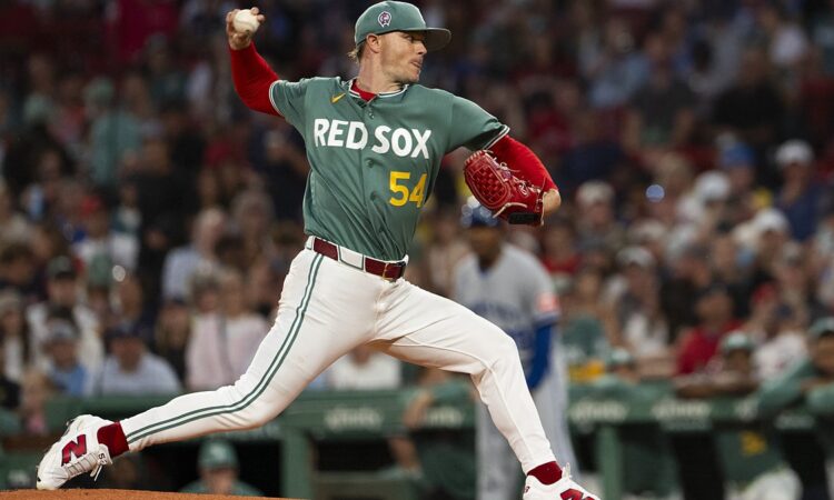 Boston Red Sox pitcher Sonny Gray strides toward the plate with the ball raised as he delivers against Kansas City.