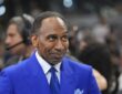 ESPN commentator Stephen A. Smith stands courtside in a blue suit before an NBA Finals game.