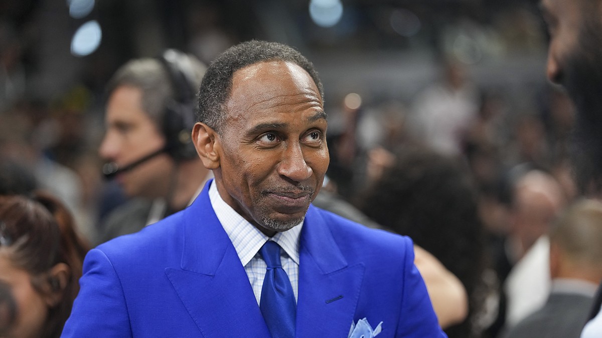 ESPN commentator Stephen A. Smith stands courtside in a blue suit before an NBA Finals game.