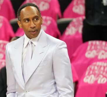 ESPN analyst Stephen A. Smith stands courtside in a light suit before an NBA Finals game.