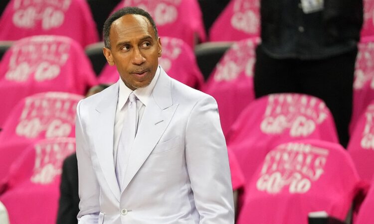 ESPN analyst Stephen A. Smith stands courtside in a light suit before an NBA Finals game.