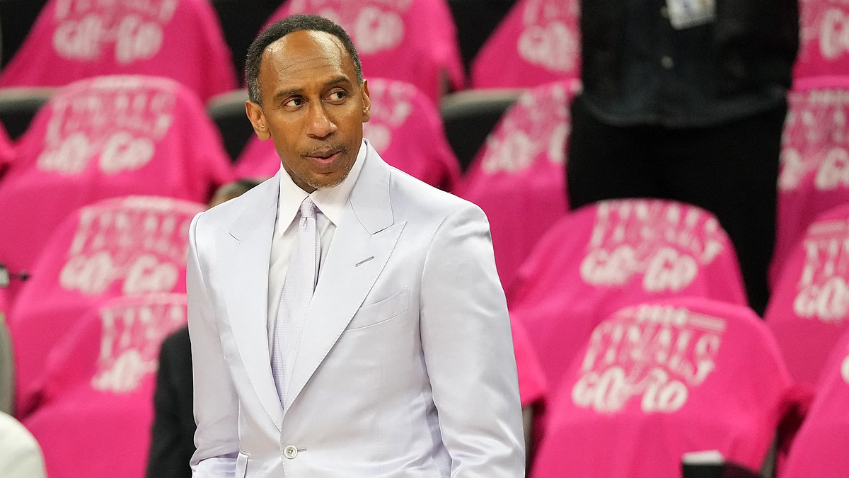 ESPN analyst Stephen A. Smith stands courtside in a light suit before an NBA Finals game.