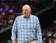 Clippers owner Steve Ballmer stands courtside in a plaid shirt watching the game against the Spurs.