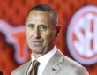 Texas Longhorns head coach Steve Sarkisian speaks in front of a Longhorns and SEC backdrop at media days.