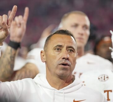 Texas Longhorns head coach Steve Sarkisian raises the Hook ’em Horns hand sign after the game against Georgia.