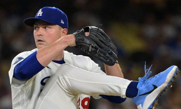 Los Angeles Dodgers starting pitcher Tarik Skubal lifts his leg high with his glove at his chin during his delivery.