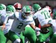 North Texas Mean Green quarterback Tayven Jackson, No. 2, extends the ball on a handoff behind his line.